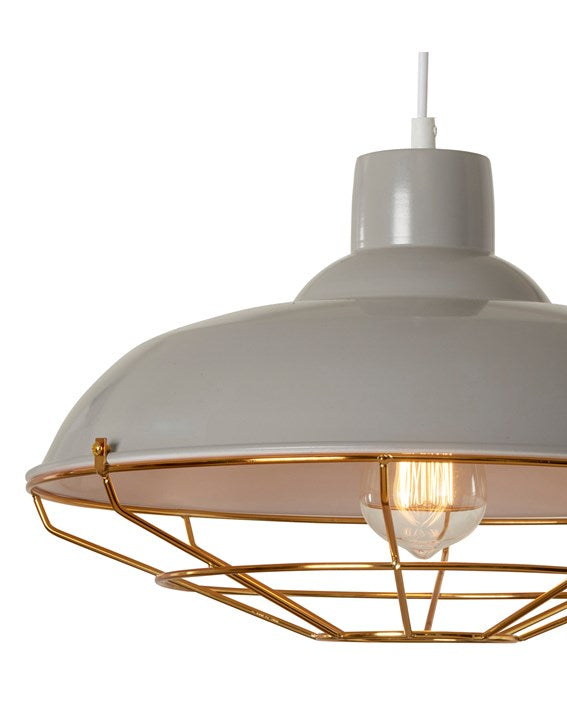 A close up shot of a grey painted metal lampshade with a copper coloured thin metal cage surrounding an illuminated bulb.