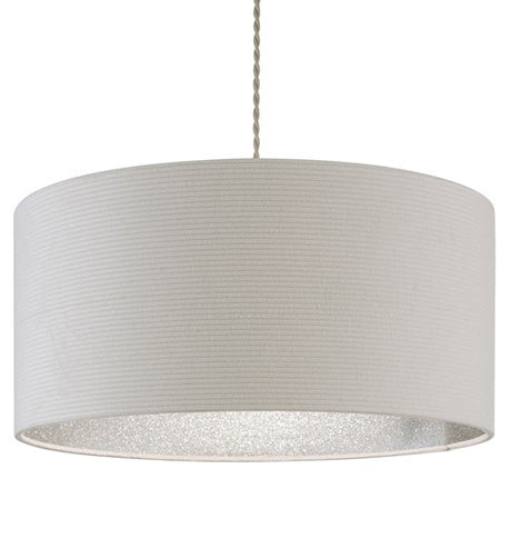 A large cylinder lampshade with a ribbed texture and just visible lining in silver glitter. The lampshade is hanging from a grey twisted cable and is taken against a white background.